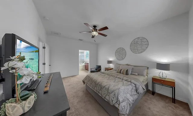 a living room with furniture a bed and a chandelier