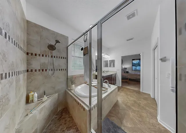 a spacious bathroom with a double vanity sink mirror and toilet