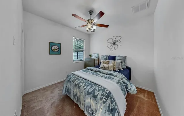 a front view of house with a yard and potted plants