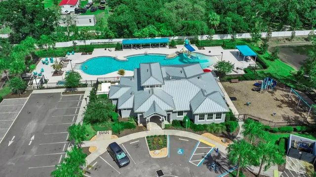 an aerial view of a house with swimming pool garden and patio