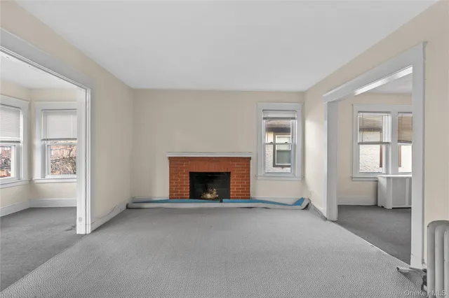 a view of empty room with a fireplace
