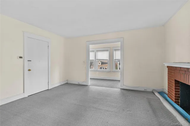 a view of an empty room with a fireplace