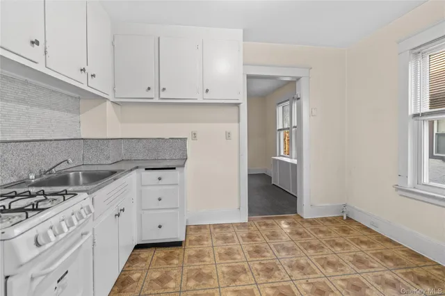 a kitchen with sink and cabinets