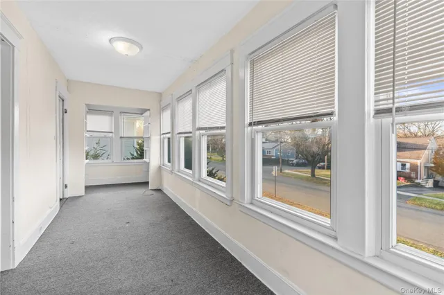 a view of a hallway with wooden shelves