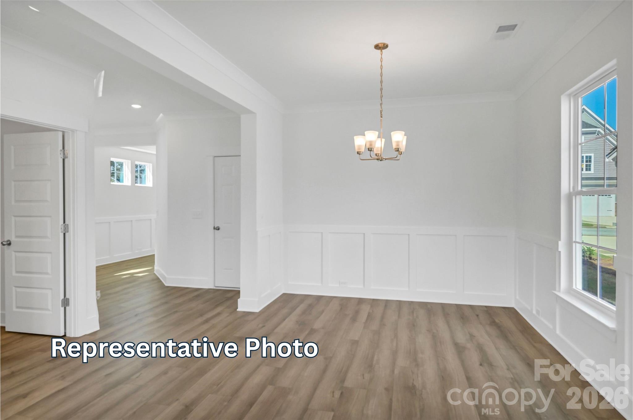13115 Foxberry Road Charlotte, NC 28213 - Photo 11 of 20 a view of an empty room with wooden floor and a window