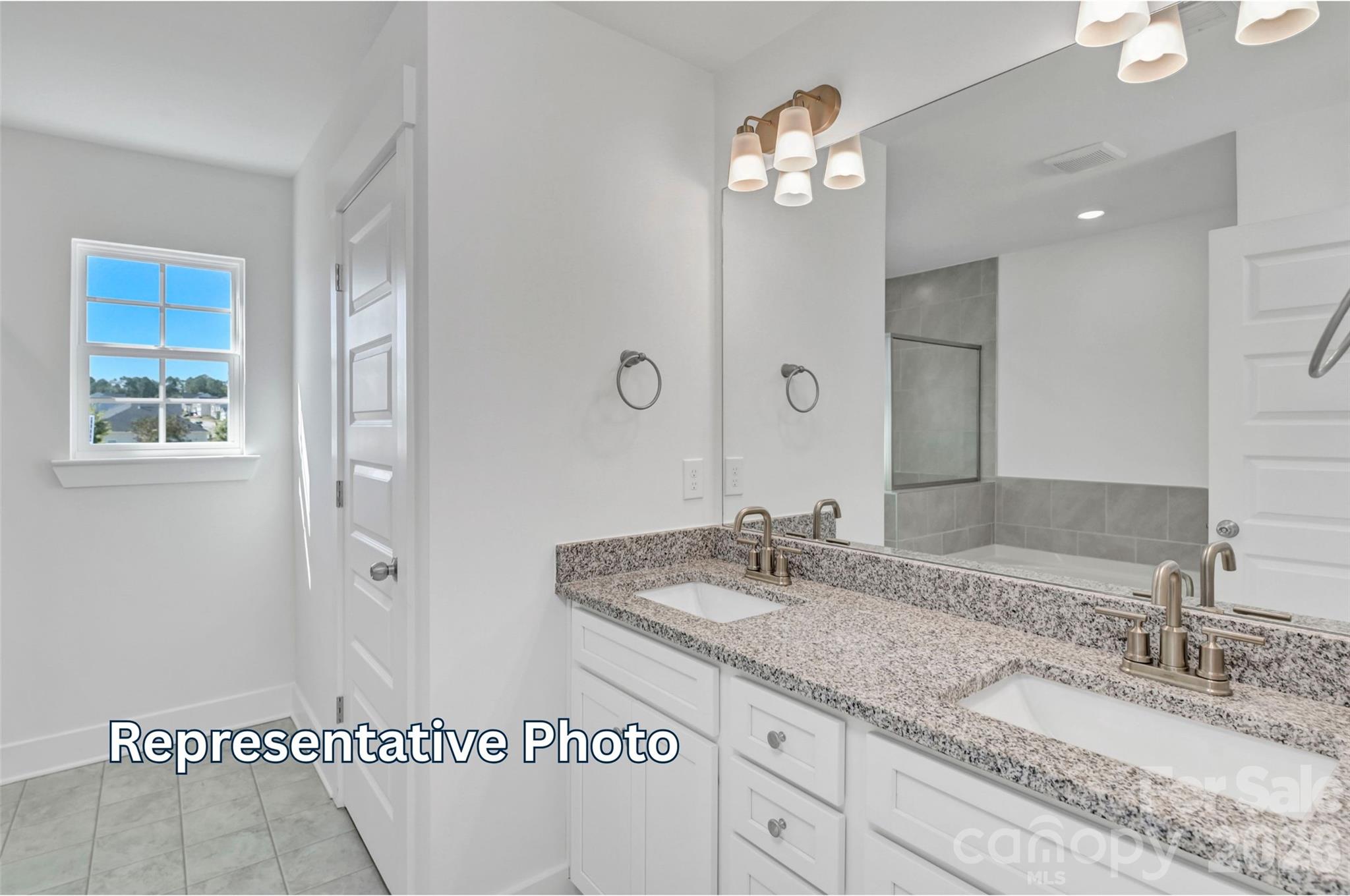 13115 Foxberry Road Charlotte, NC 28213 - Photo 16 of 20 a bathroom with a sink a vanity and a mirror