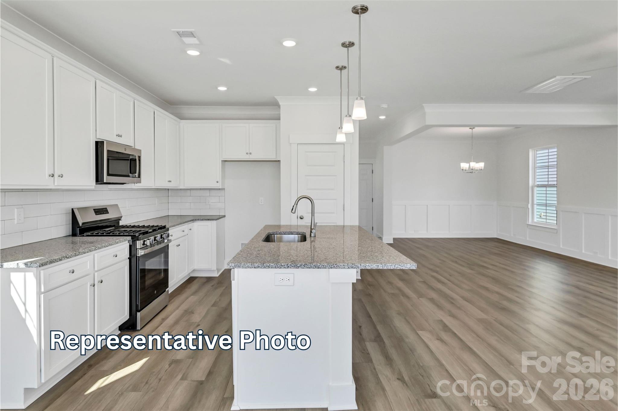 13115 Foxberry Road Charlotte, NC 28213 - Photo 5 of 20 a kitchen with stainless steel appliances granite countertop a sink a stove top oven a counter space and cabinets