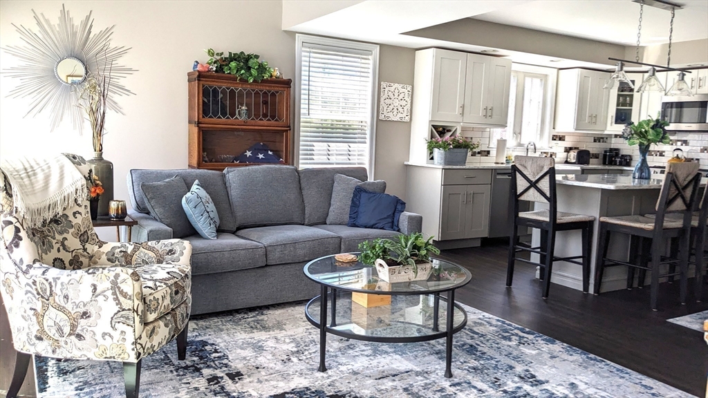53 Baldwin Road, Unit 201 Billerica, MA 01821 - Photo 11 of 35 a living room with furniture potted plant and a table