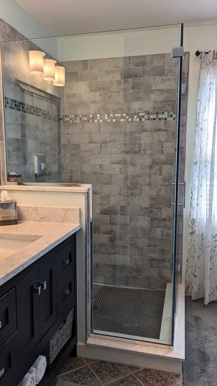 53 Baldwin Road, Unit 201 Billerica, MA 01821 - Photo 19 of 35 a bathroom with a shower and a sink