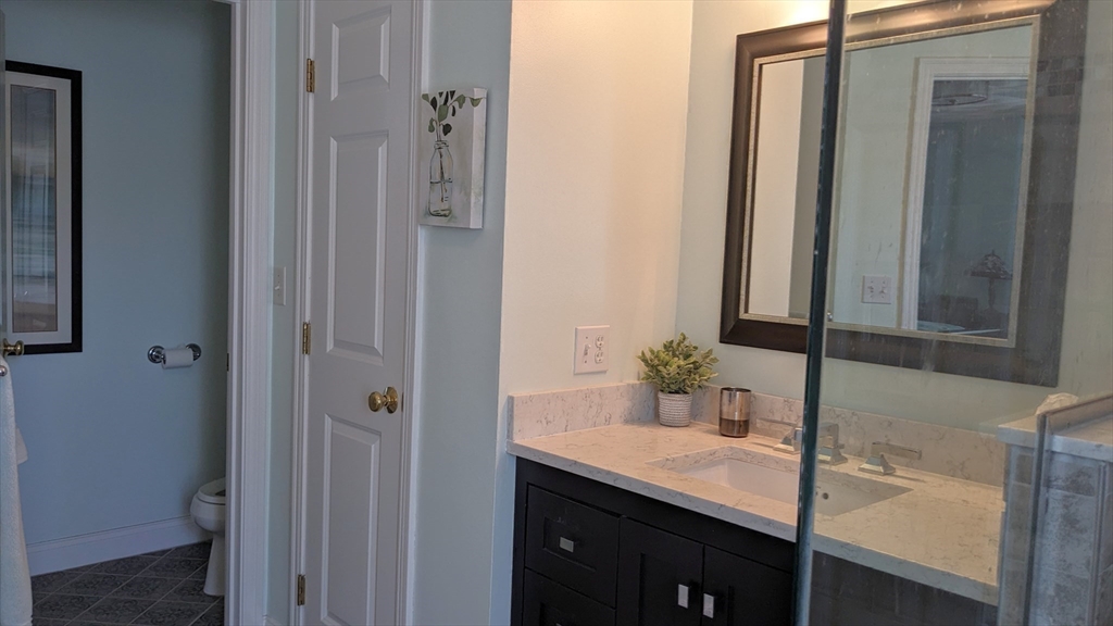 53 Baldwin Road, Unit 201 Billerica, MA 01821 - Photo 20 of 35 a bathroom with a sink and a mirror