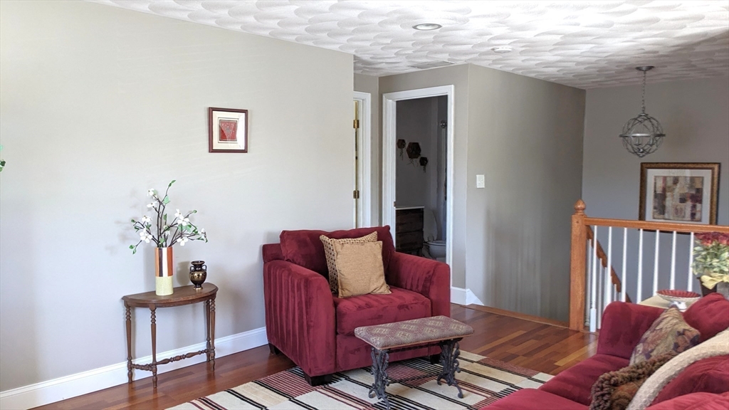 53 Baldwin Road, Unit 201 Billerica, MA 01821 - Photo 23 of 35 a living room with furniture a rug and a window