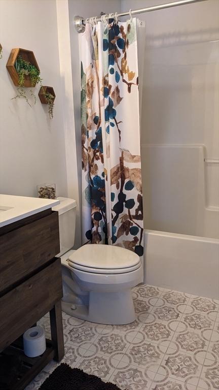 53 Baldwin Road, Unit 201 Billerica, MA 01821 - Photo 28 of 35 a white toilet sitting next to a bathroom sink and tub