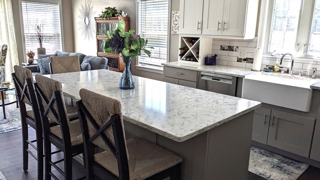 53 Baldwin Road, Unit 201 Billerica, MA 01821 - Photo 5 of 35 a kitchen with a table chairs sink and cabinets