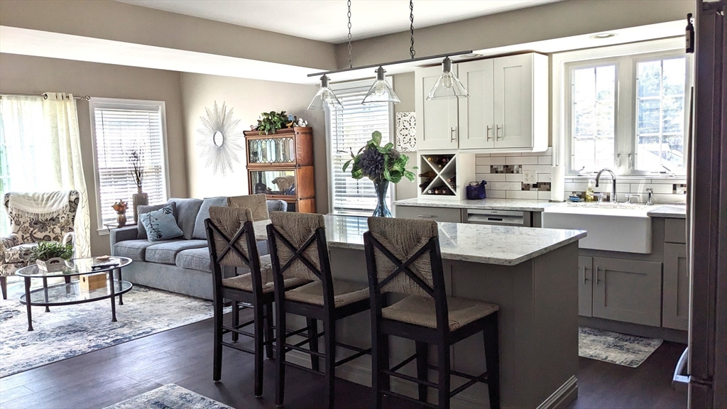 53 Baldwin Road, Unit 201 Billerica, MA 01821 - Photo 6 of 35 a kitchen with a table chairs stove and cabinets