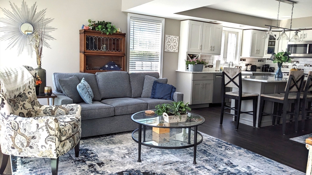 53 Baldwin Road, Unit 201 Billerica, MA 01821 - Photo 8 of 35 a living room with furniture potted plant and a table