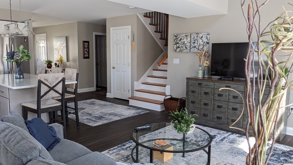 53 Baldwin Road, Unit 201 Billerica, MA 01821 - Photo 9 of 35 a living room with furniture and a flat screen tv