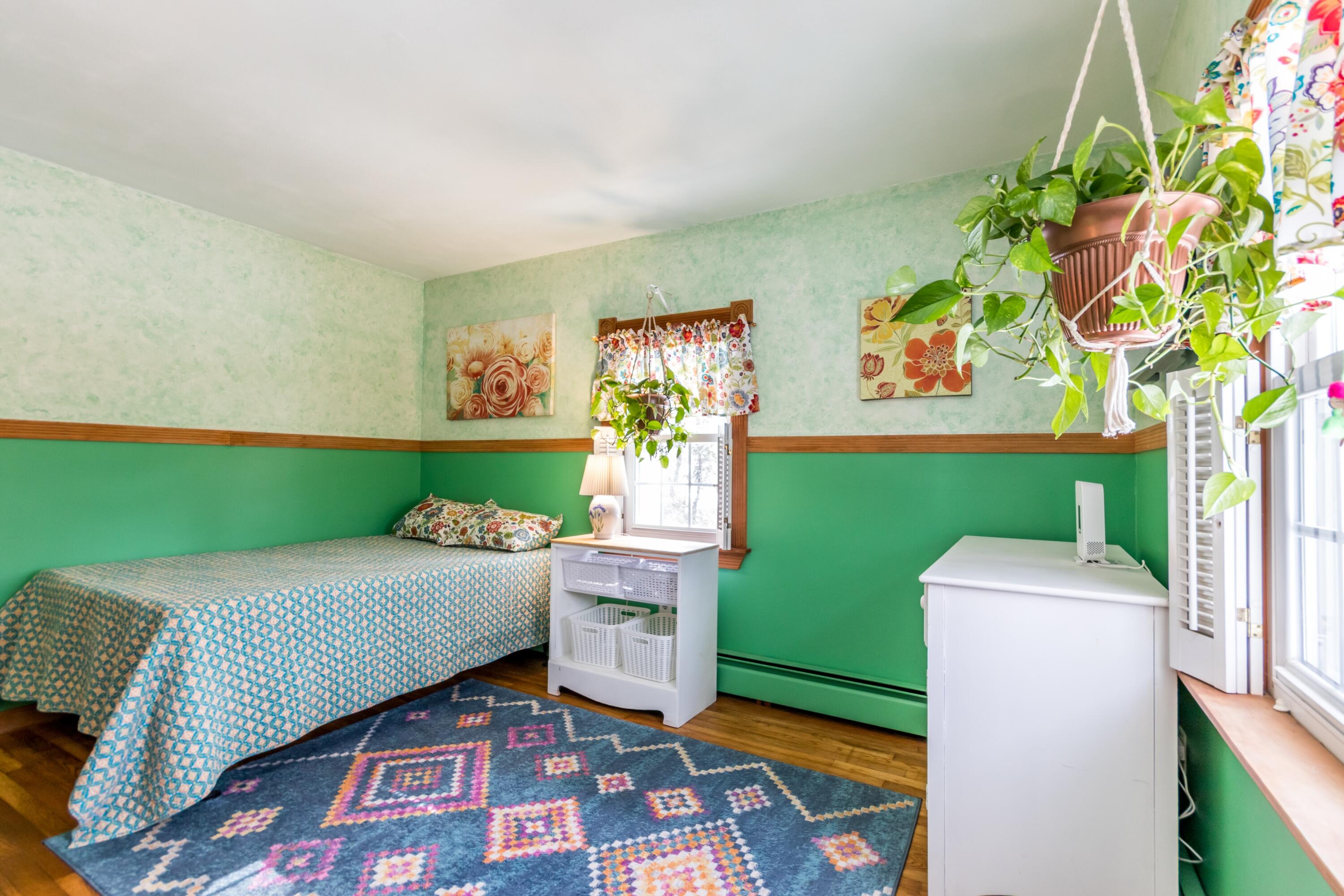 58 Maple Street Buzzards Bay, MA 02532 - Photo 13 of 29 a bed room with a bed and a painting on the wall