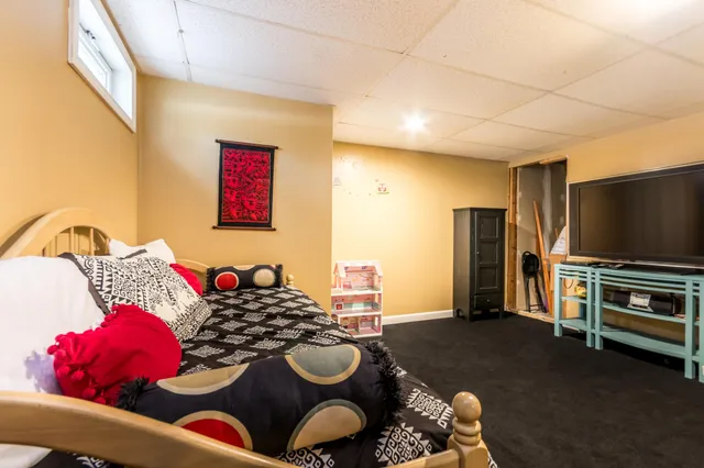 a bedroom with furniture and a flat screen tv