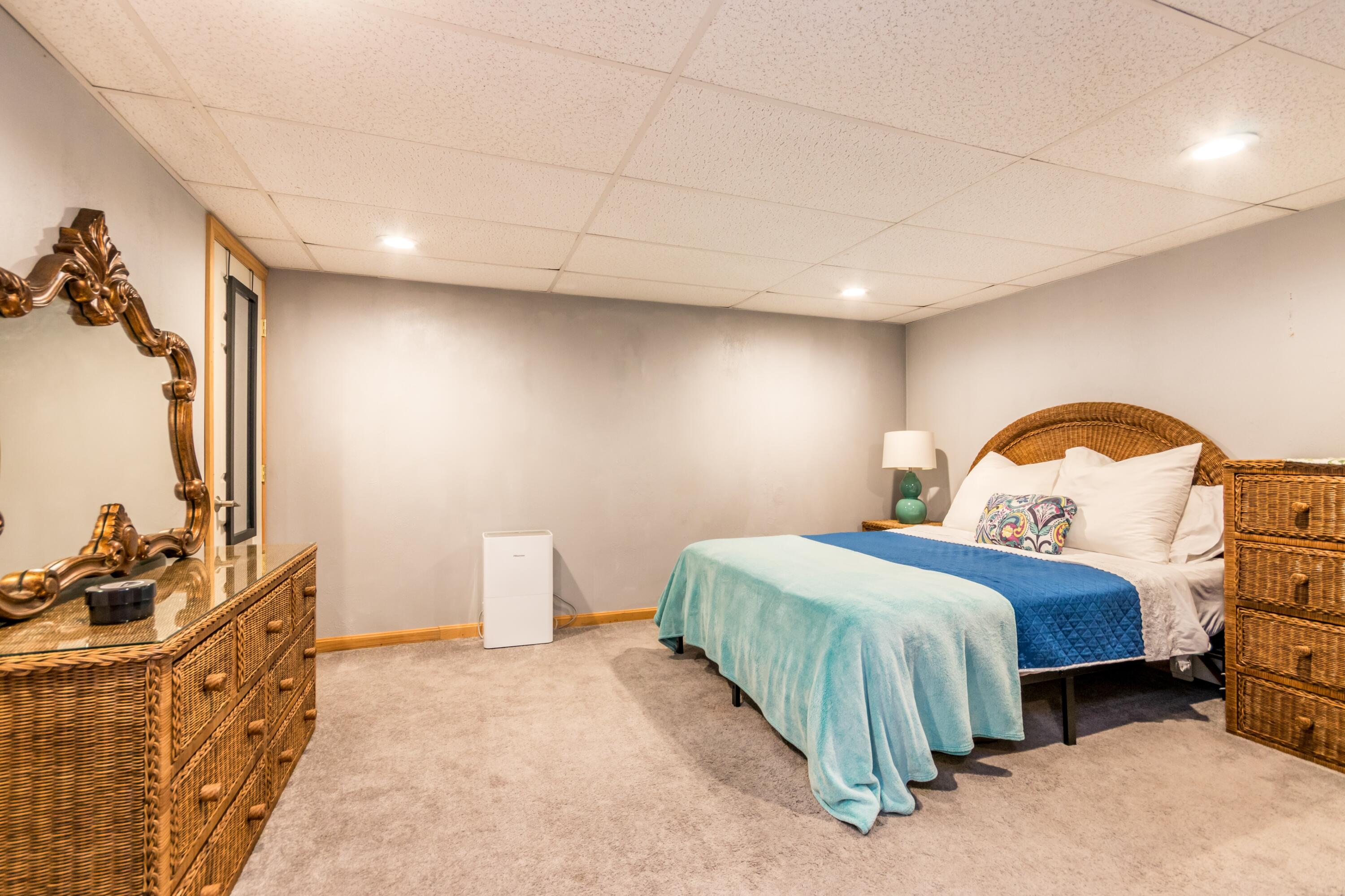 58 Maple Street Buzzards Bay, MA 02532 - Photo 19 of 29 a bedroom with a bed and a dresser with mirror