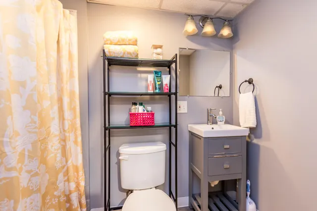 a bathroom with a toilet sink and mirror