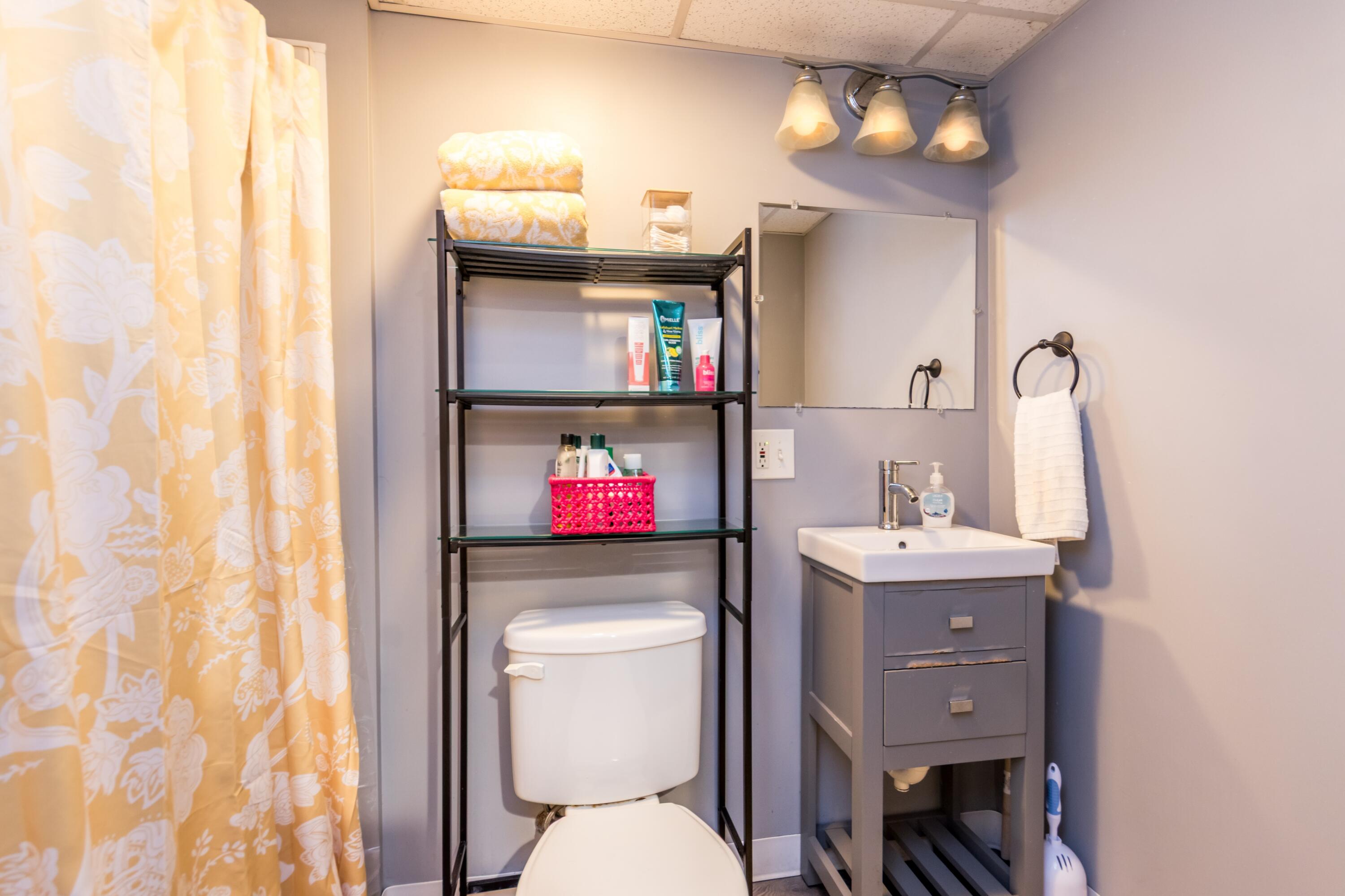 58 Maple Street Buzzards Bay, MA 02532 - Photo 20 of 29 a bathroom with a toilet sink and mirror