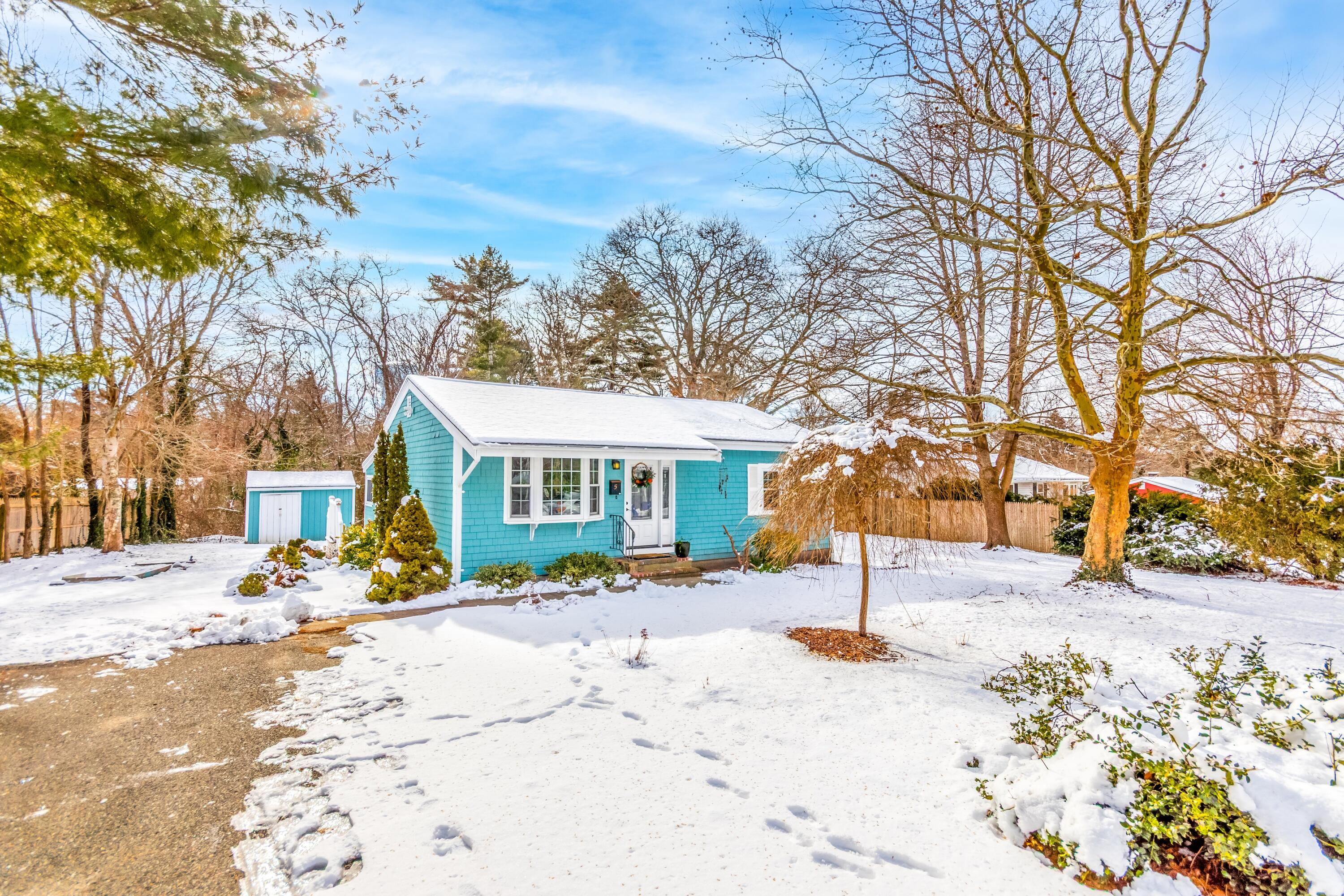 58 Maple Street Buzzards Bay, MA 02532 - Photo 23 of 29 a front view of a house with a yard covered with snow