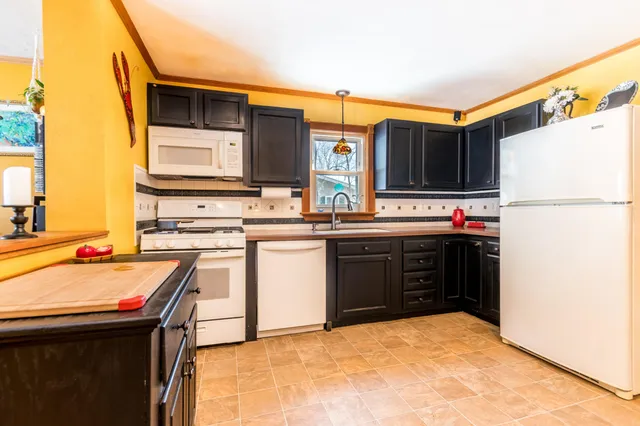 a kitchen with stainless steel appliances a stove sink and microwave