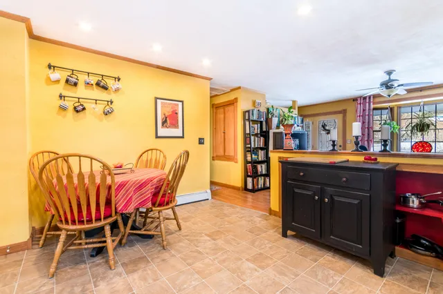 a living room with a table and chairs