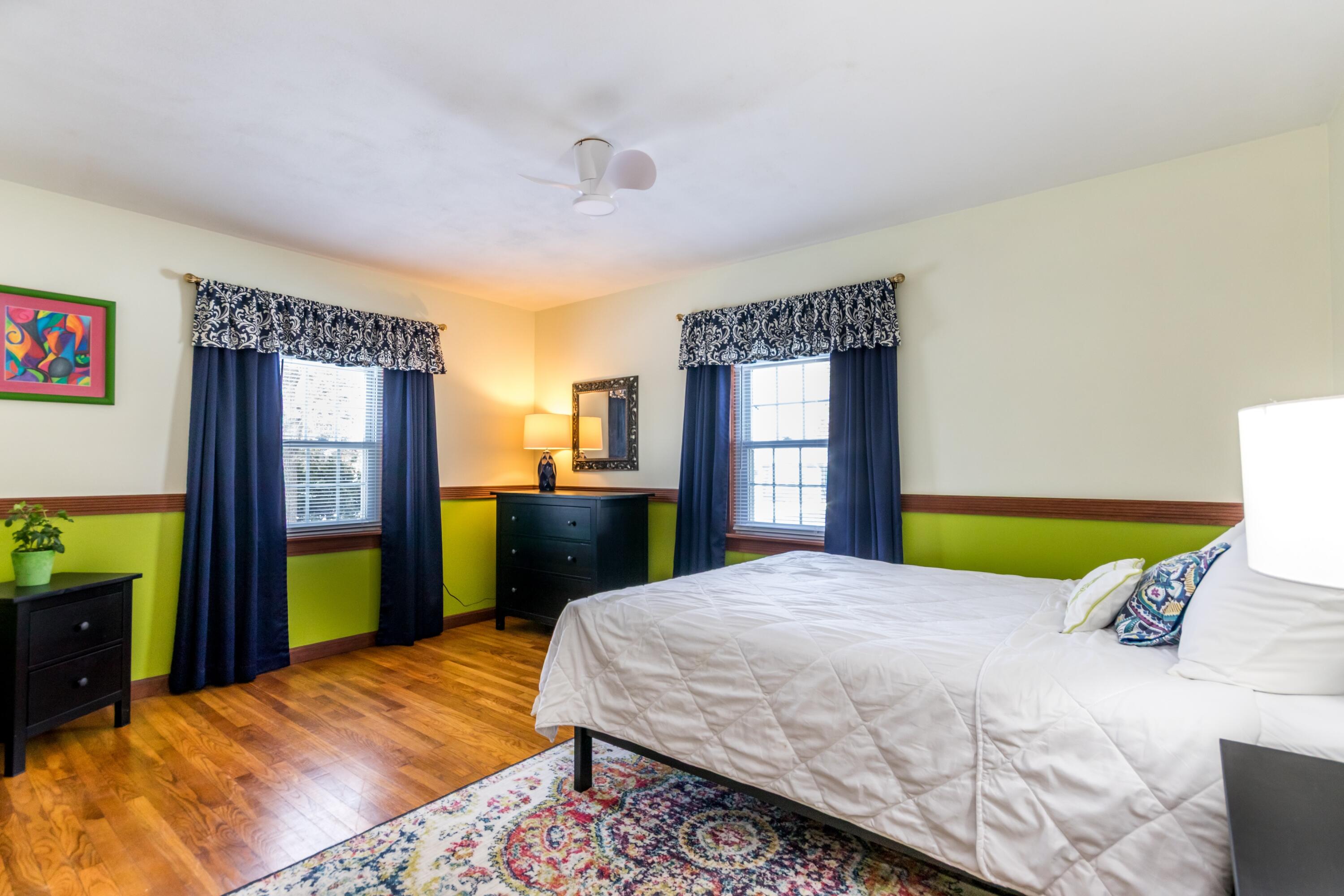 58 Maple Street Buzzards Bay, MA 02532 - Photo 10 of 29 a bedroom with a bed and a dresser next to a window