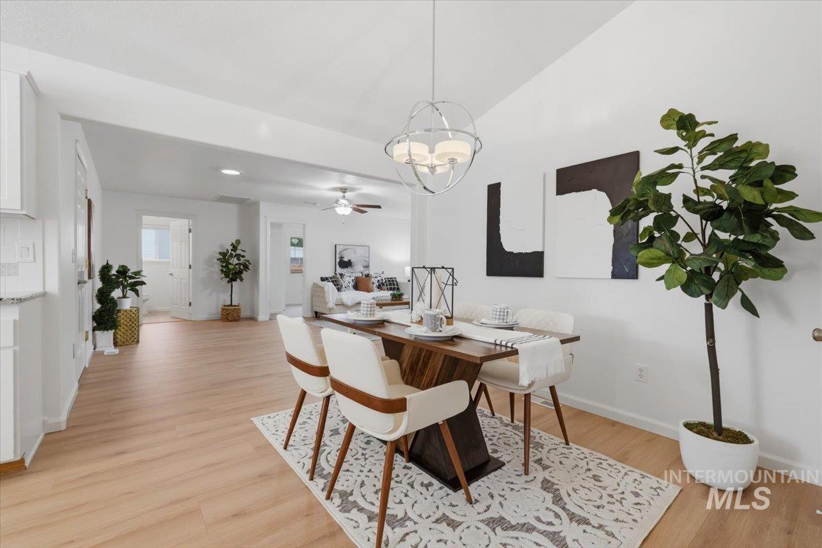 2075 North Springland Place Boise, ID 83713 - Photo 9 of 49 Open-concept dining area featuring light wood-finish flooring and a contemporary spherical chandelier