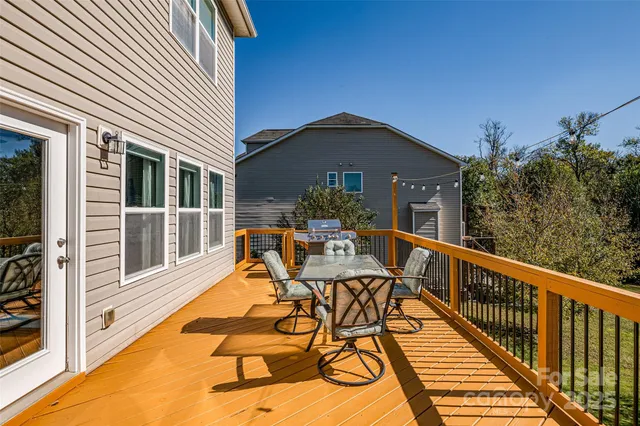a view of a patio with chairs next to a yard
