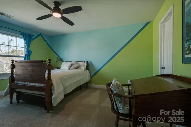 a bedroom with a bed chair and a window