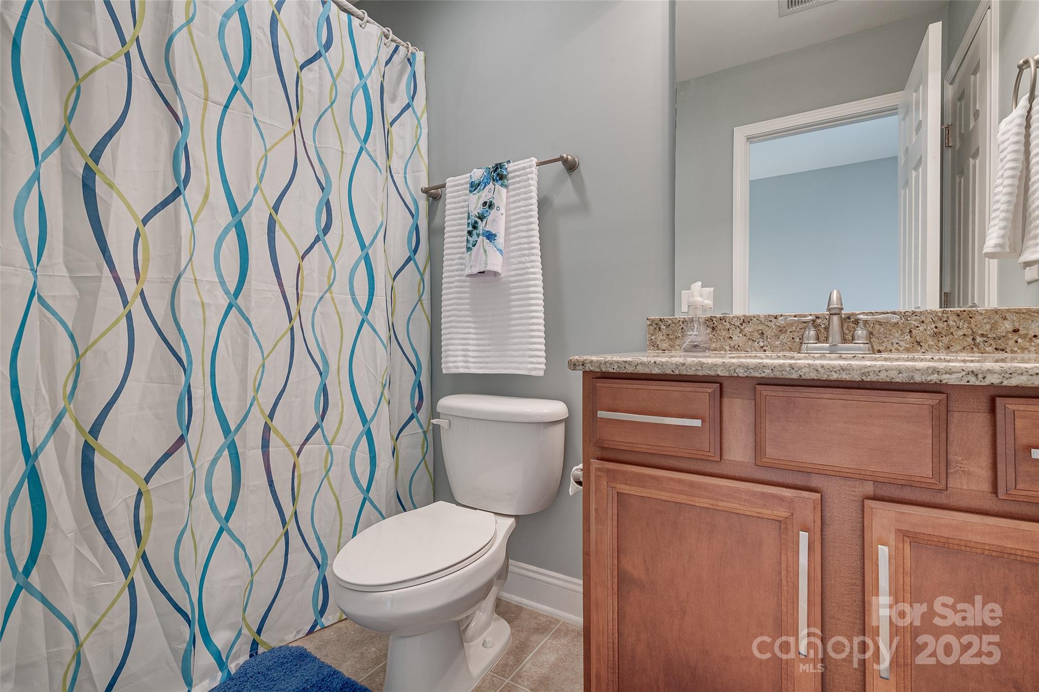 1266 Lange Court Fort Mill, SC 29715 - Photo 18 of 45 a bathroom with a granite countertop toilet sink and mirror