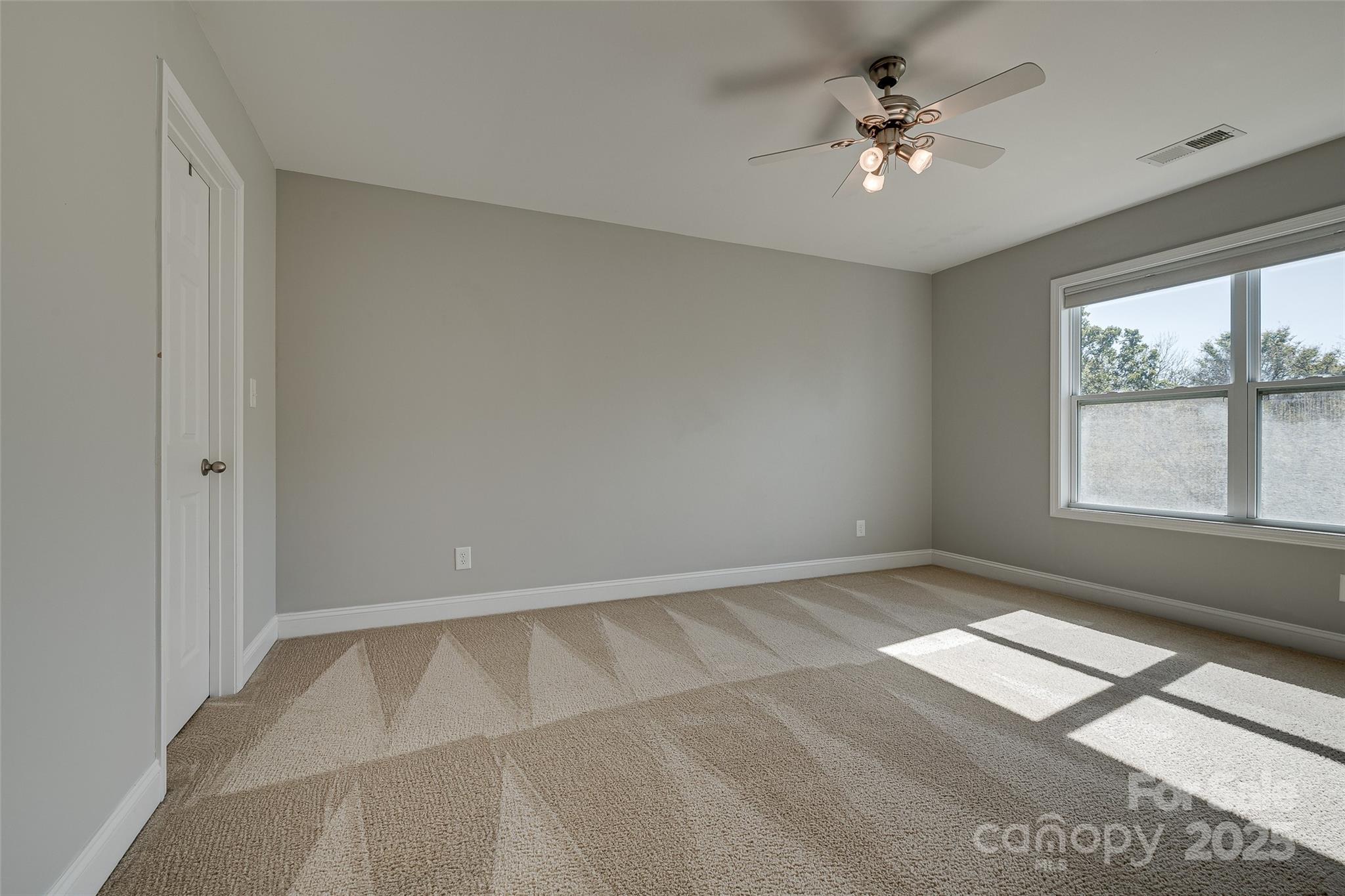 1266 Lange Court Fort Mill, SC 29715 - Photo 20 of 45 an empty room with windows and ceiling fan
