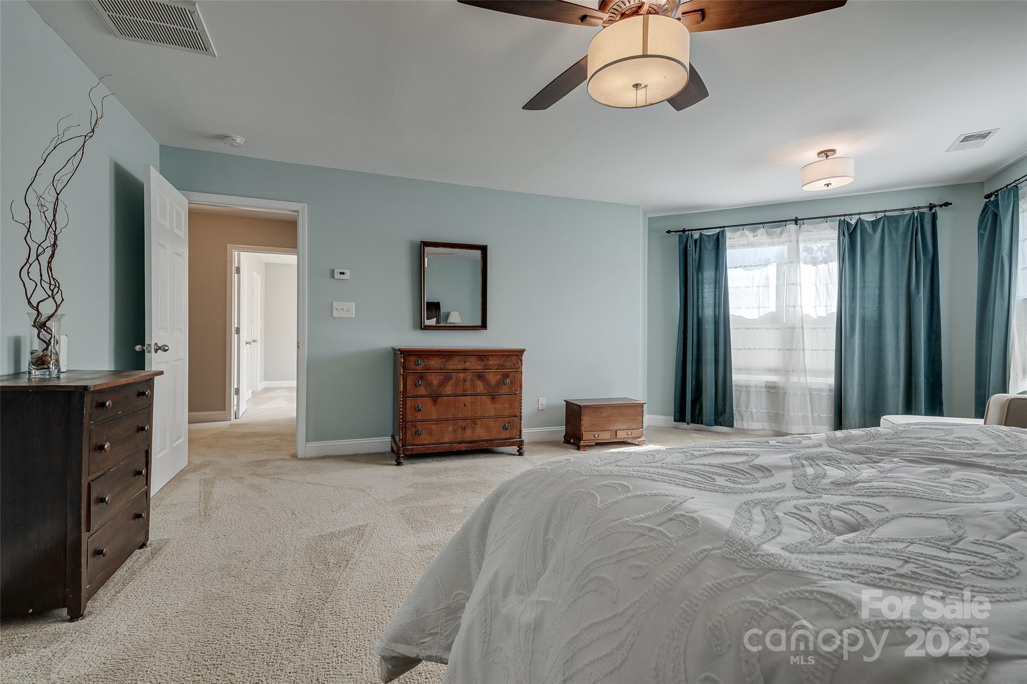 1266 Lange Court Fort Mill, SC 29715 - Photo 24 of 45 a large bedroom with a bed and a chandelier