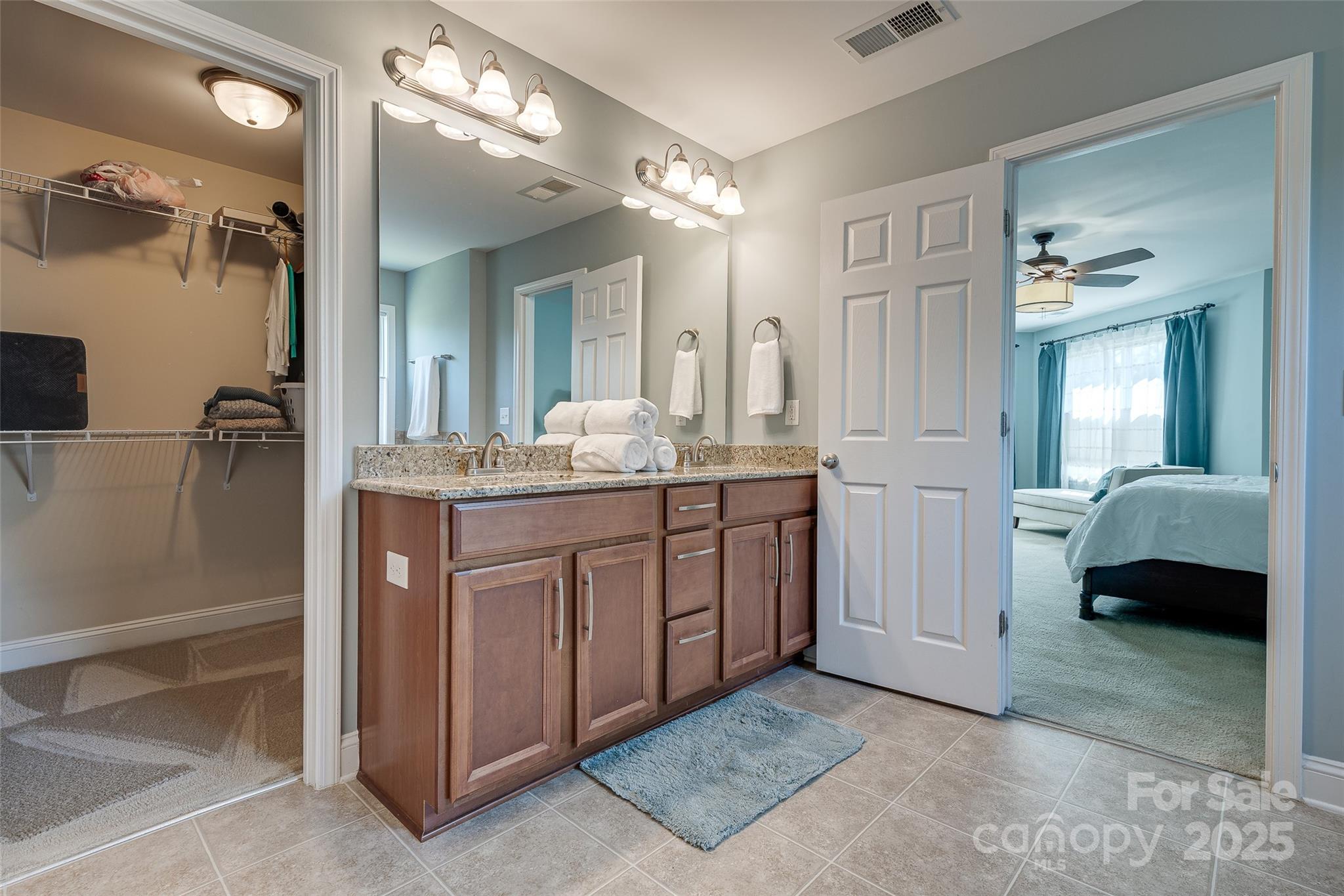 1266 Lange Court Fort Mill, SC 29715 - Photo 25 of 45 a en suite bathroom with a double vanity sink a mirror and shower