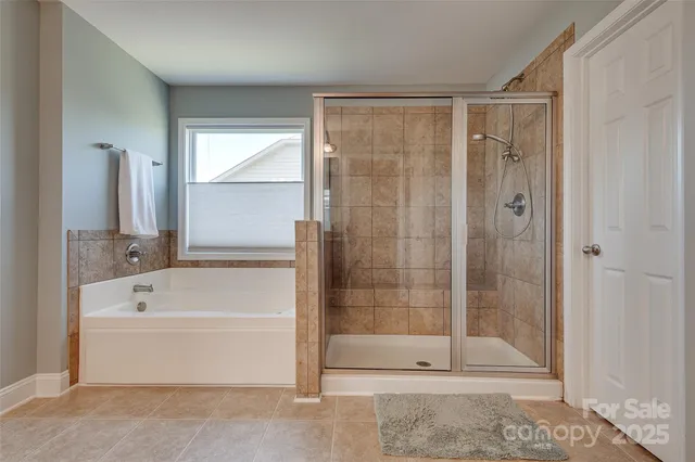 a bathroom with a shower a bathtub and a shower