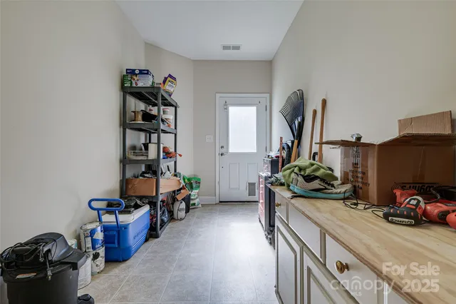 a living room with furniture gym equipment and a large window