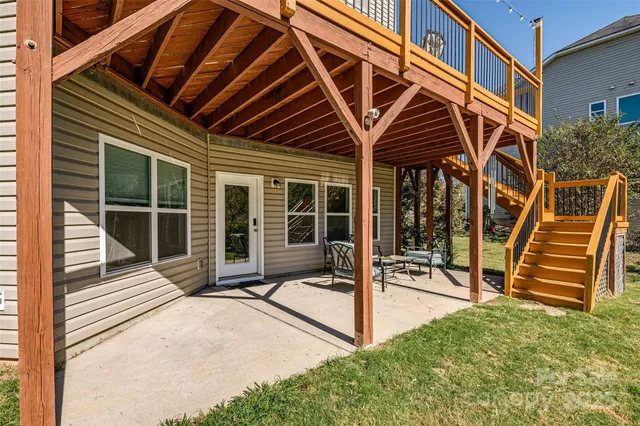 a view of a house with a large window and wooden fence