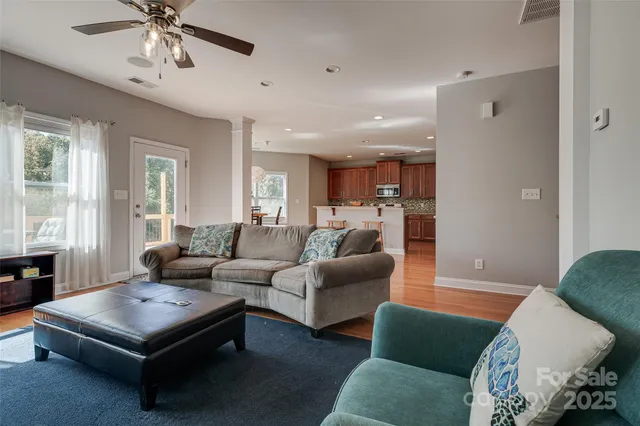 a living room with furniture and a chandelier