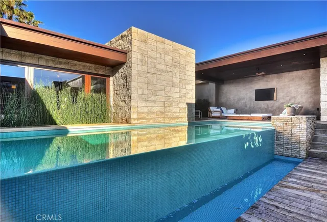 a view of swimming pool with a chair and tables