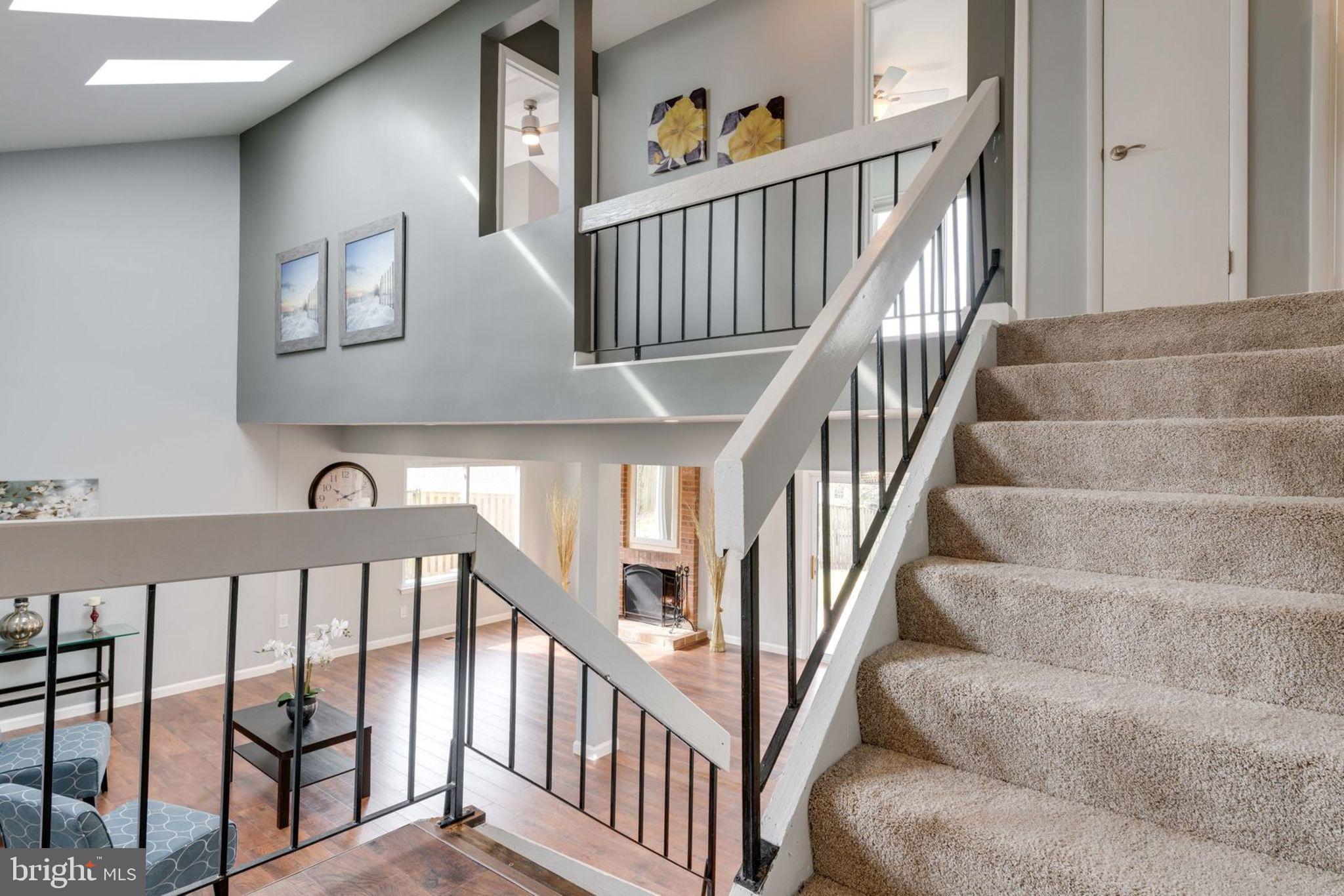 7627 Mineral Spring Court Springfield, VA 22153 - Photo 6 of 34 a view of staircase with lots of frames on wall and a window
