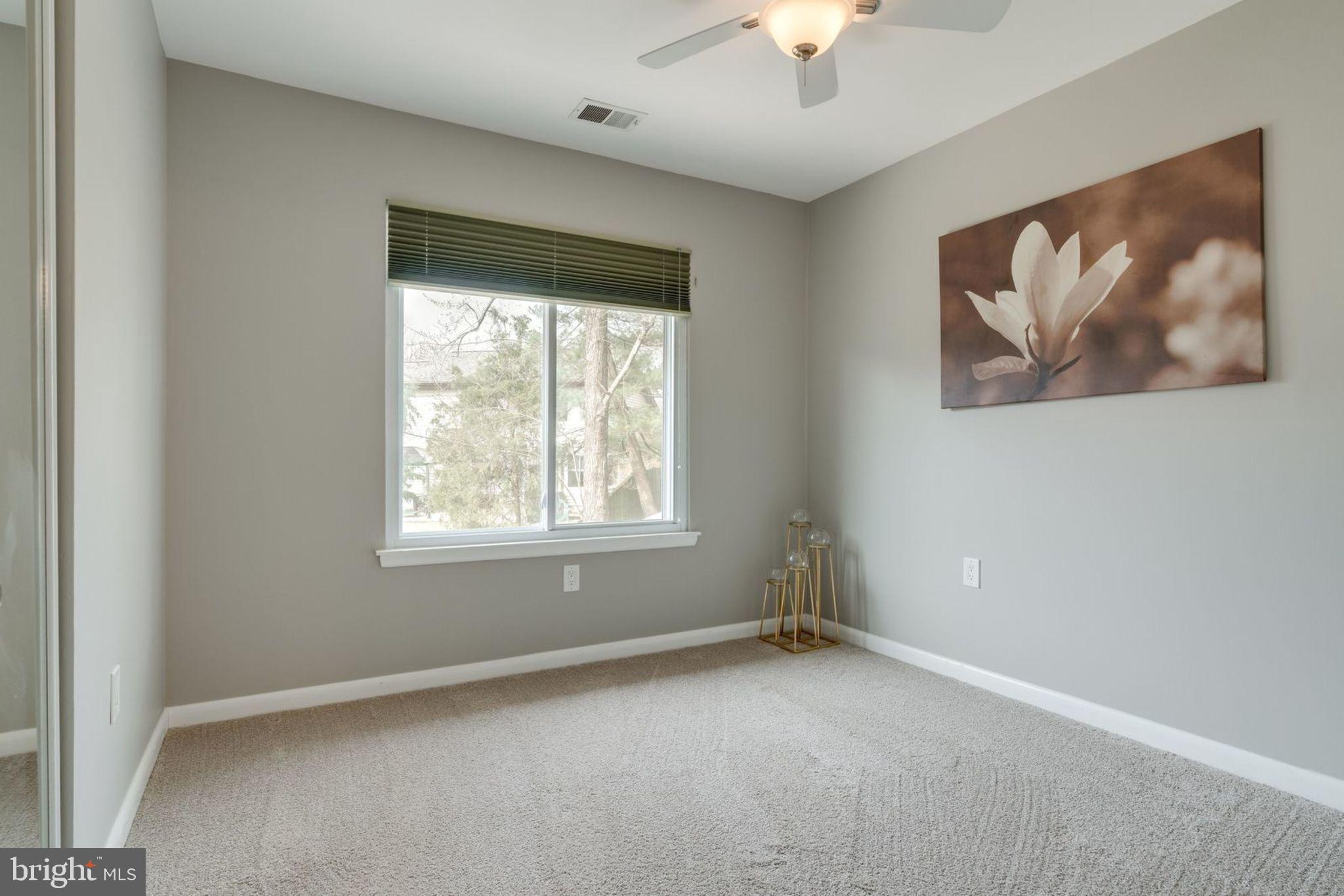7627 Mineral Spring Court Springfield, VA 22153 - Photo 10 of 34 an empty room with a window and a painting on the wall