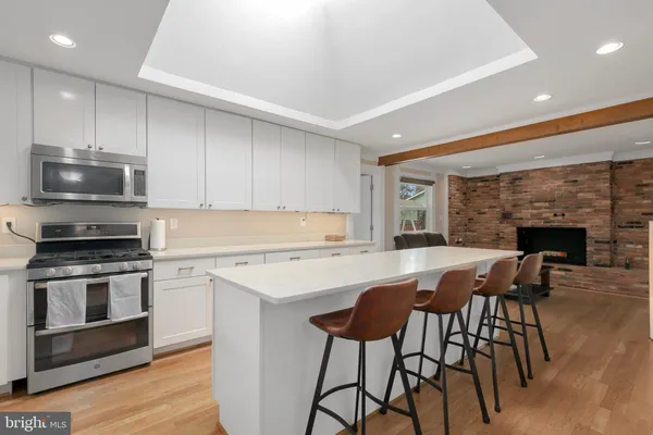 a kitchen with a sink stove and microwave