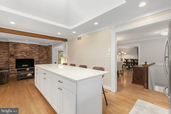 a kitchen with white cabinets appliances and sink