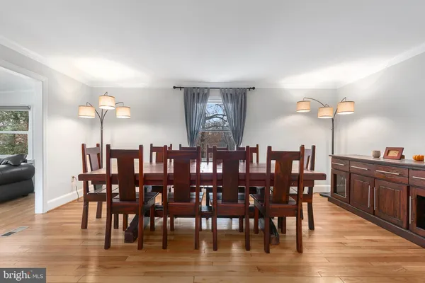 a dining room with furniture and wooden floor