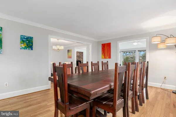 a view of a dining room with furniture wooden floor and chandelier