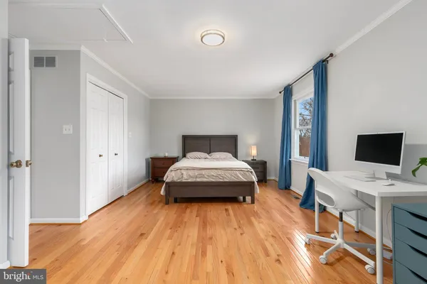 a spacious bedroom with a bed and a white cabinets