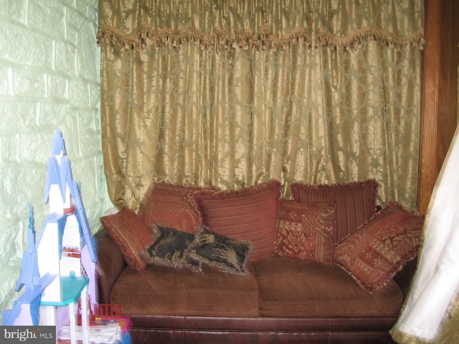 177 Wellington Road Upper Darby, PA 19082 - Photo 19 of 20 a living room with furniture and a window