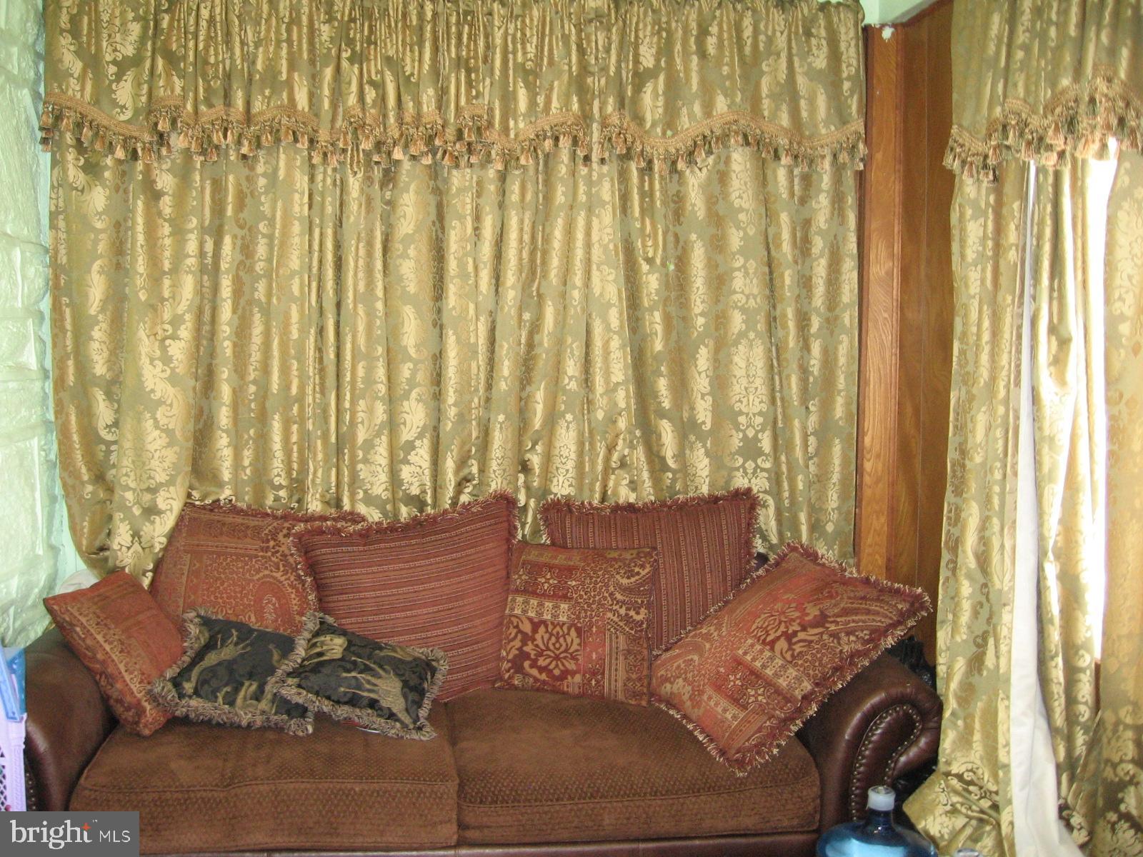 177 Wellington Road Upper Darby, PA 19082 - Photo 4 of 20 a bed sitting in a bedroom next to a window